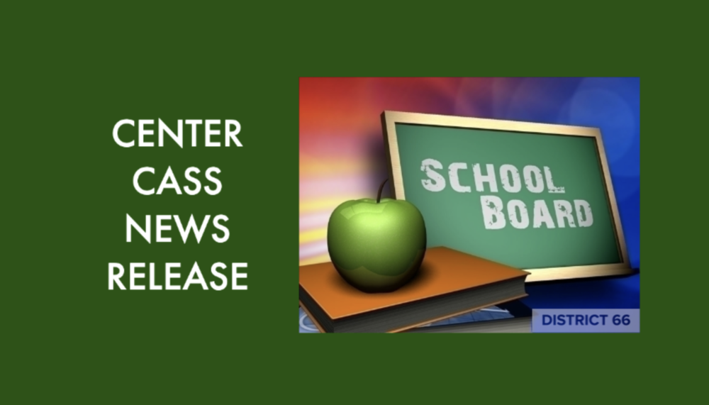 books and apple next to chalkboard