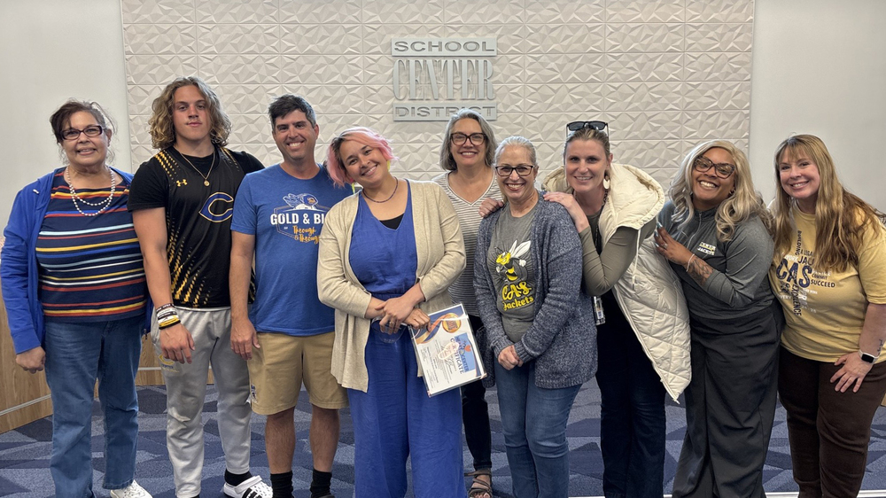 April Heart of Center Recipient Dani Banion stands with her family and colleagues.