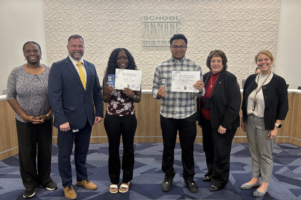 September Yellowjackets of the Month stand with the Superintendent, Assistant Superintendent, and board members.