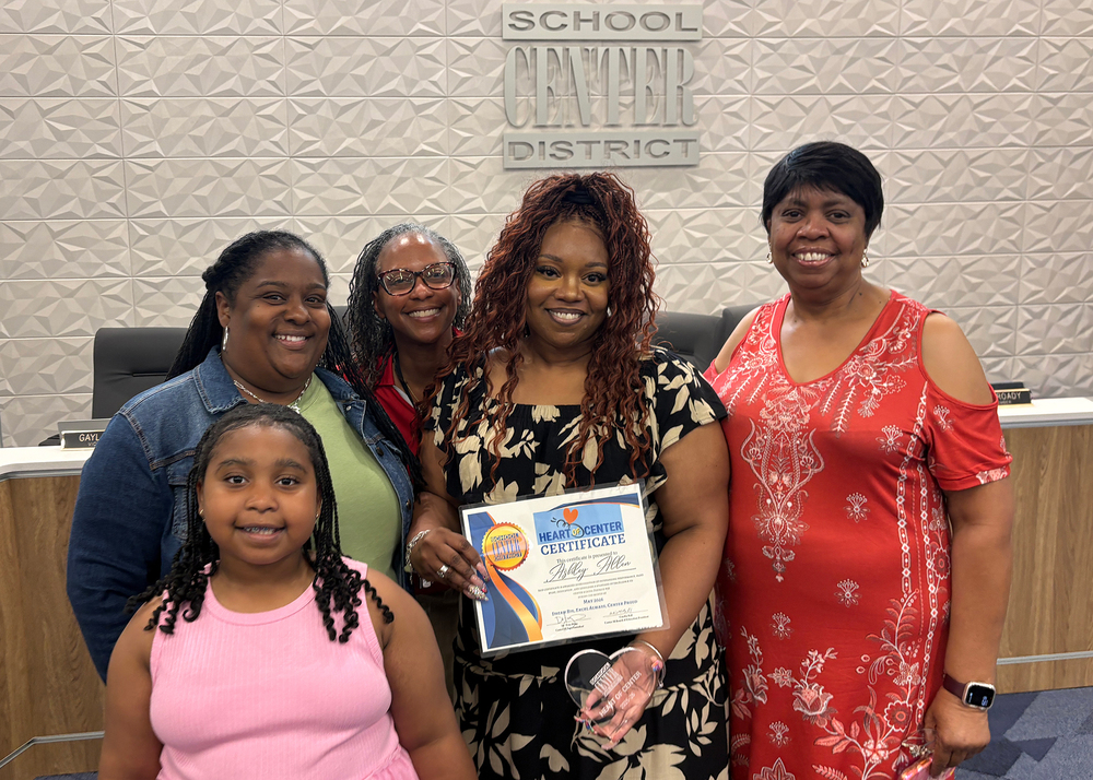 May Heart of Center Recipient Ashley Allen stands with her family and colleagues.