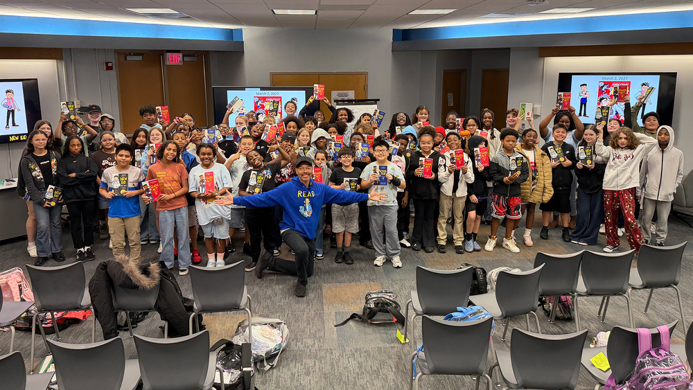 Jerry Craft stands with Center Middle School sixth grade students. 