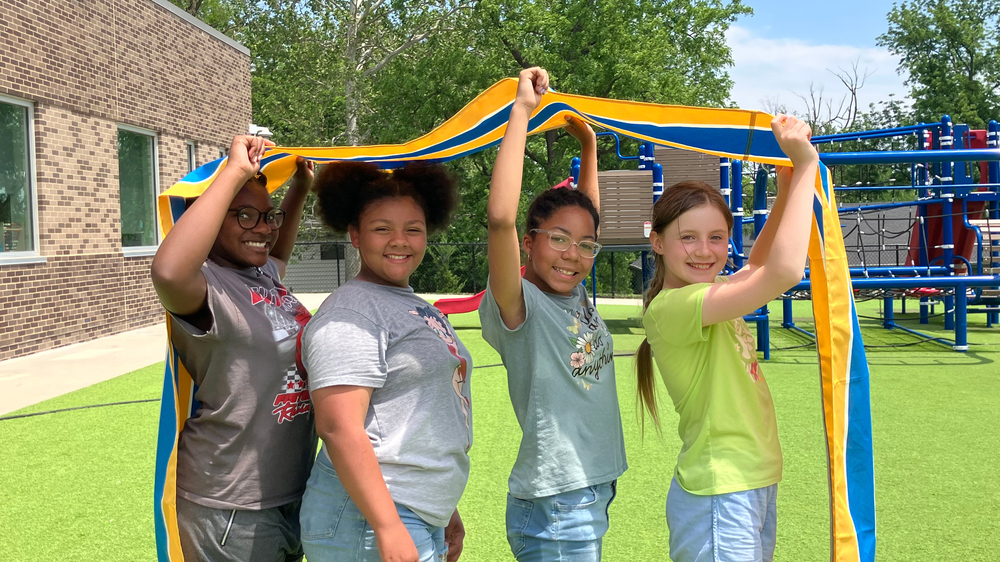 Four students stand on the Indian Creek Elementary School playground.