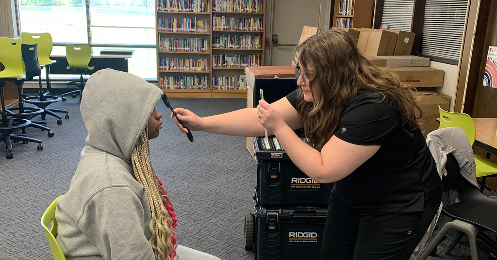 Student receives eye exam from Access KC.