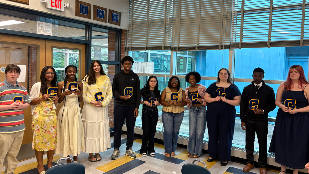 Seniors with Academic Letters stand in a line in the cafeteria.