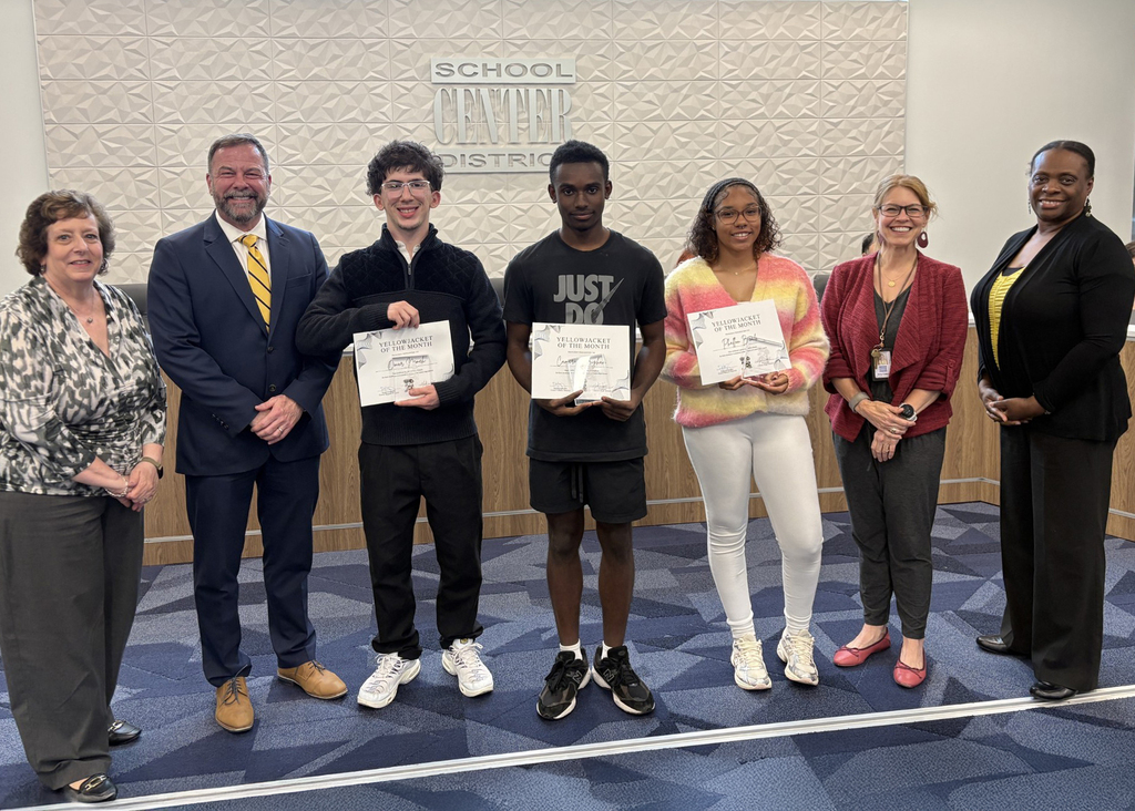April Yellowjacket of the Month Recipients stand with their certificates at Board of Education meeting.