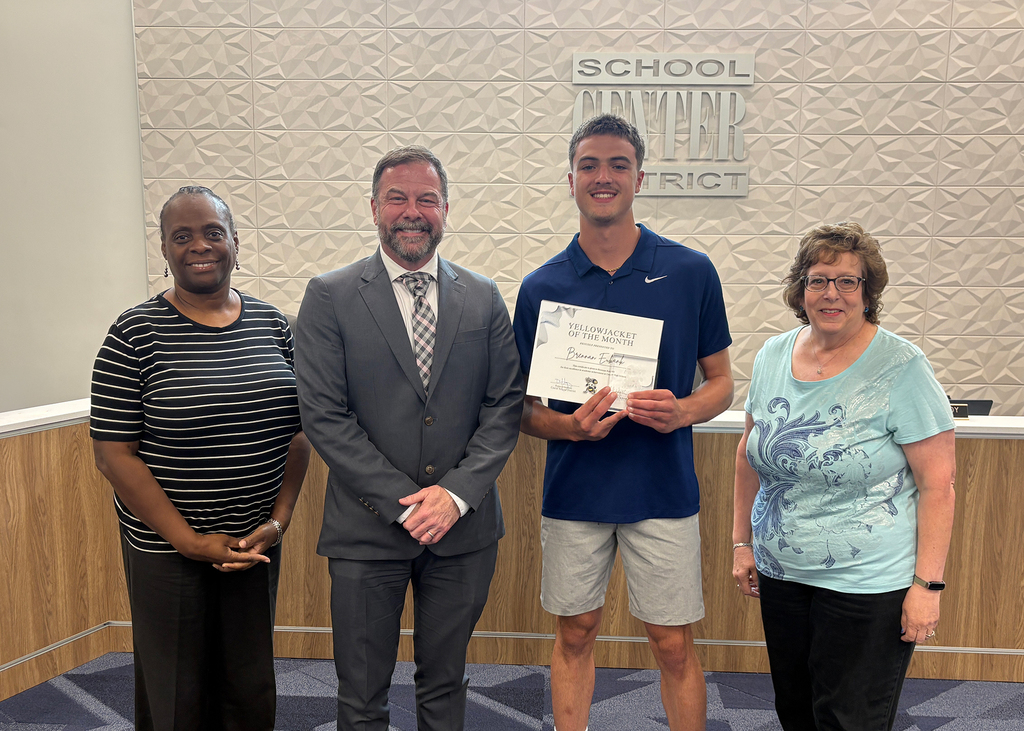 May Yellowjacket of the Month Recipient stands with their certificates at Board of Education meeting.