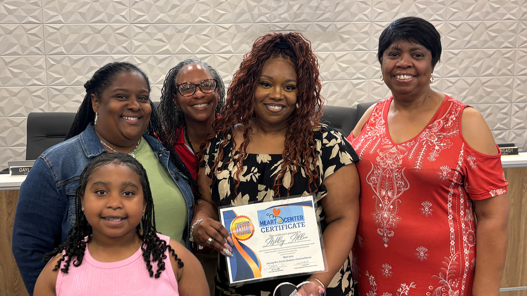 May Heart of Center Recipient Ashley Allen stands with her family and colleagues.