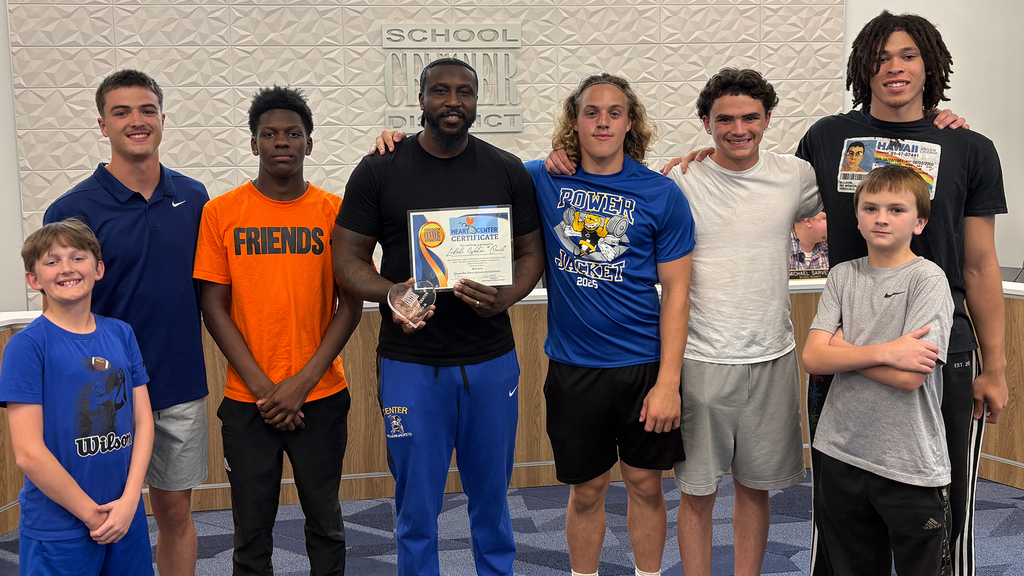 May Heart of Center Recipient LeDale Wooten stands smiling with his students.