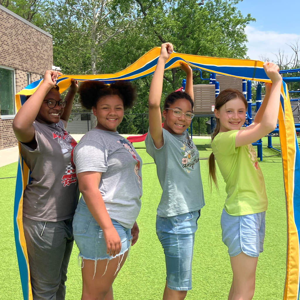 Four students stand on the Indian Creek Elementary School playground.