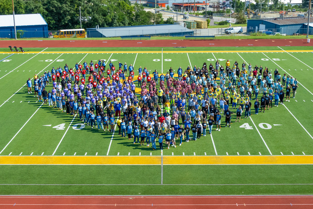 Center School District staff on the CHS football field, standing in the shape of a heart.