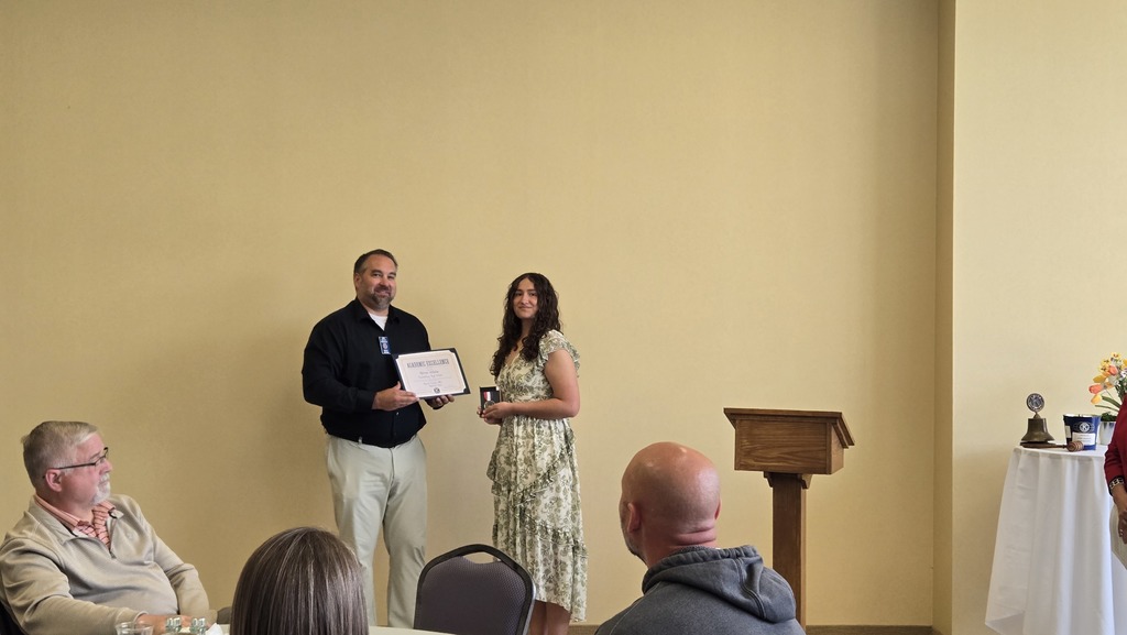 Ally receives her award. 