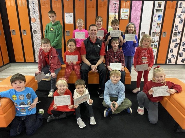 students holding awards with the principal