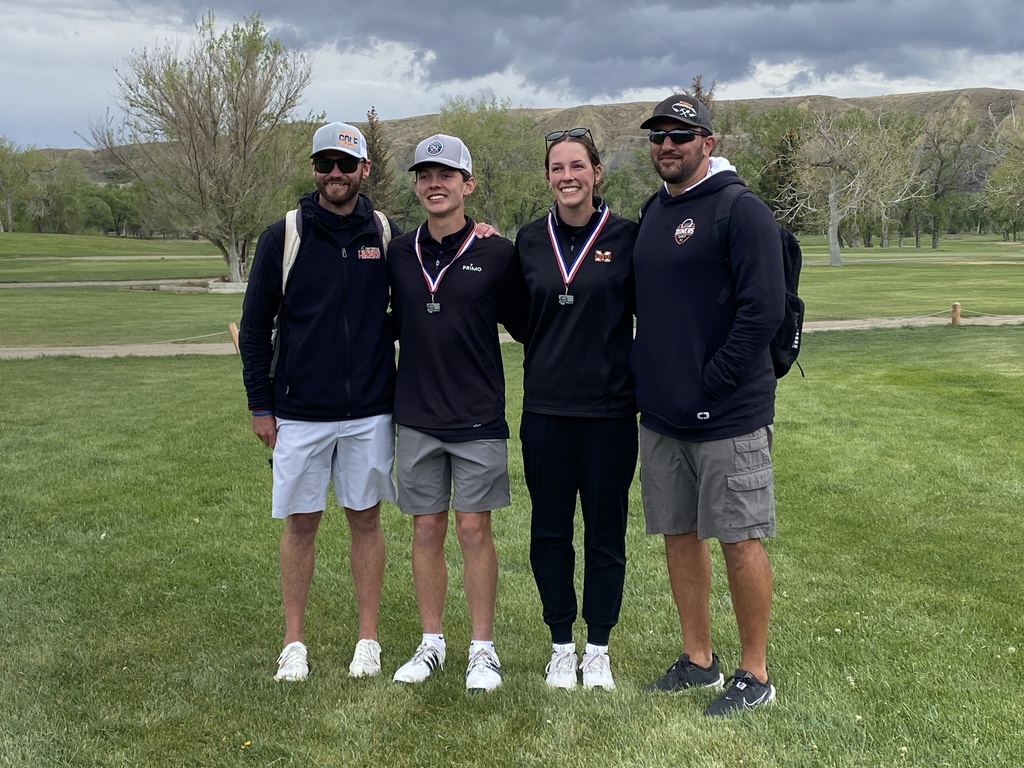 2 second place golfers and 2 coaches on a golf course
