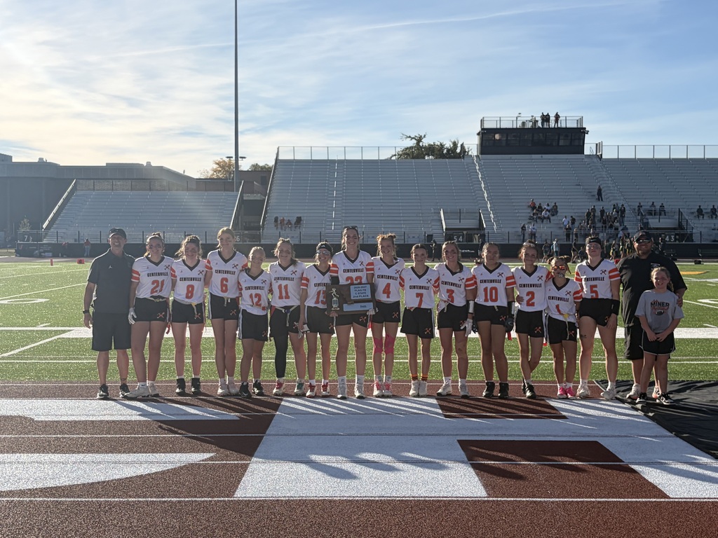 flag football players and coaches, middle payer holding the trophy