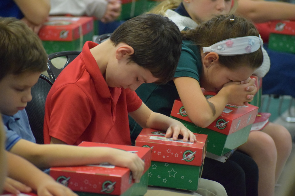 Praying over the shoebox gifts.