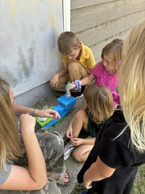 First Graders learning to use science tools.