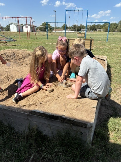 First Graders learning to use science tools.