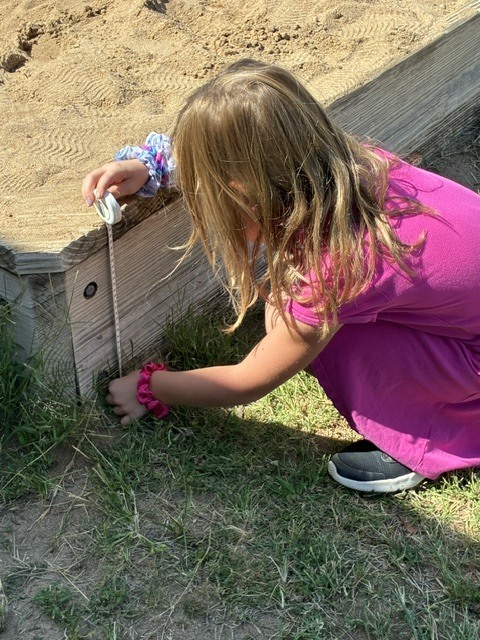 First Graders learning to use science tools.