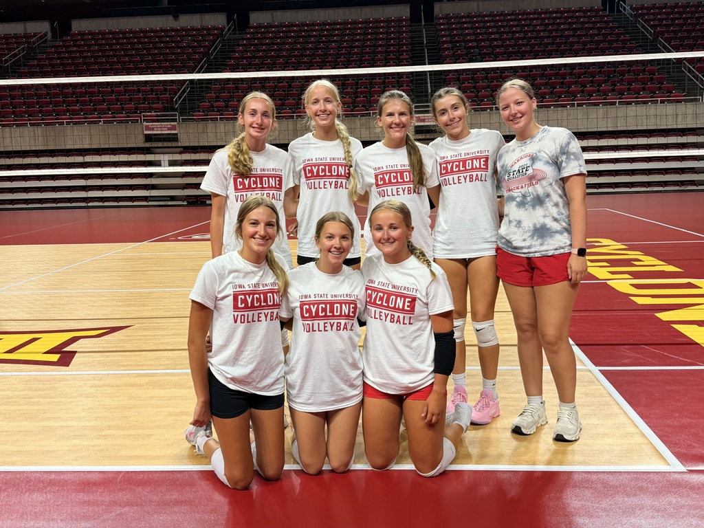 Volleyball team members posing for picture