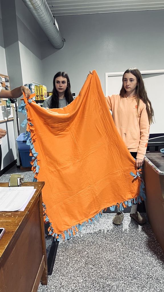 Students showing a tie blanket