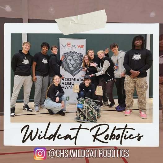 Some chs robotics members next to their robot