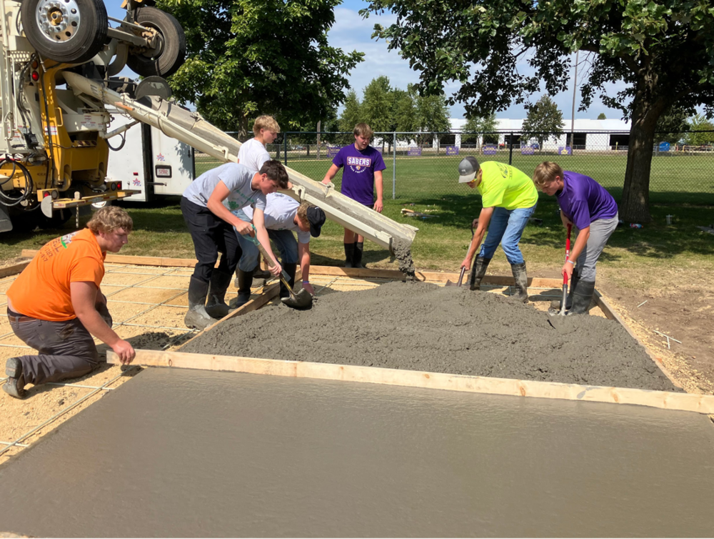 Building Trades students pouring concrete