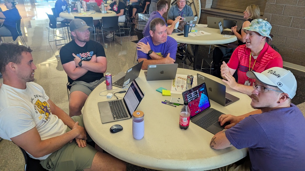 Teachers and administration collaborating at Portrait of a Saber launch