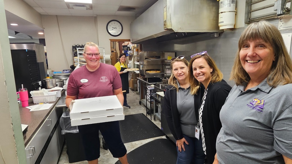 Education Foundation members picking up pizzas from MJ's