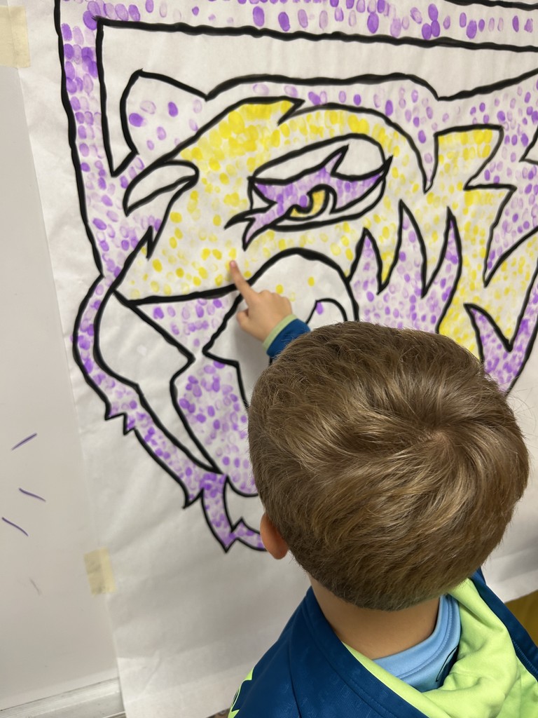 Students putting their fingerprint on Saber Spirit art project