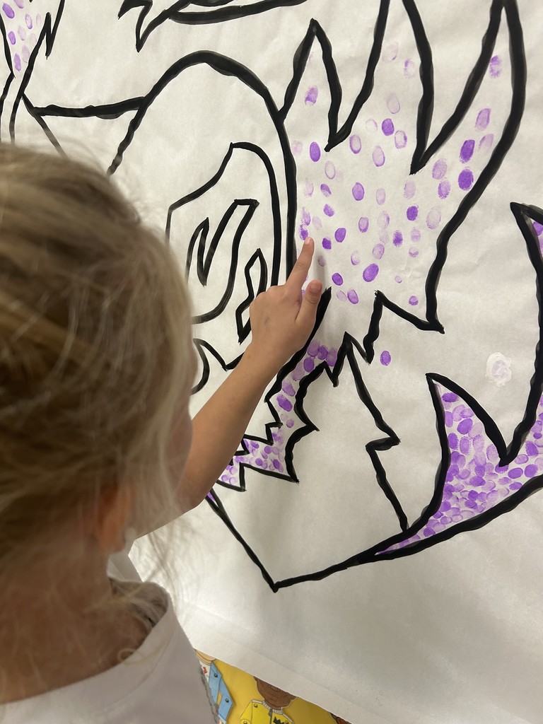 Students putting their fingerprint on Saber Spirit art project