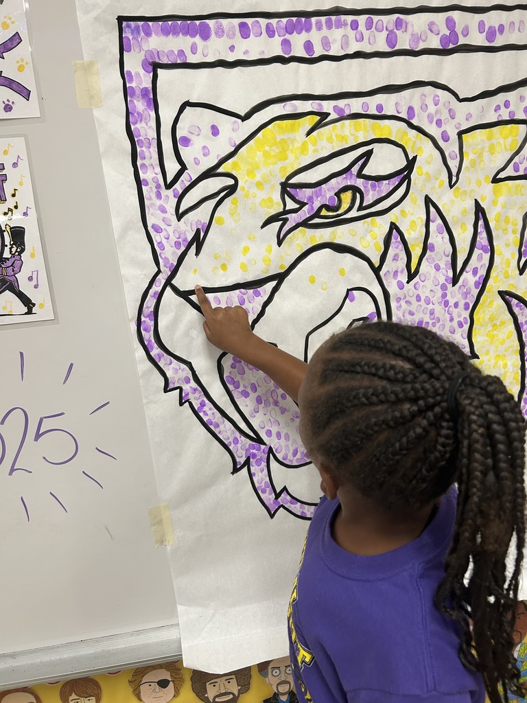 Students putting their fingerprint on Saber Spirit art project