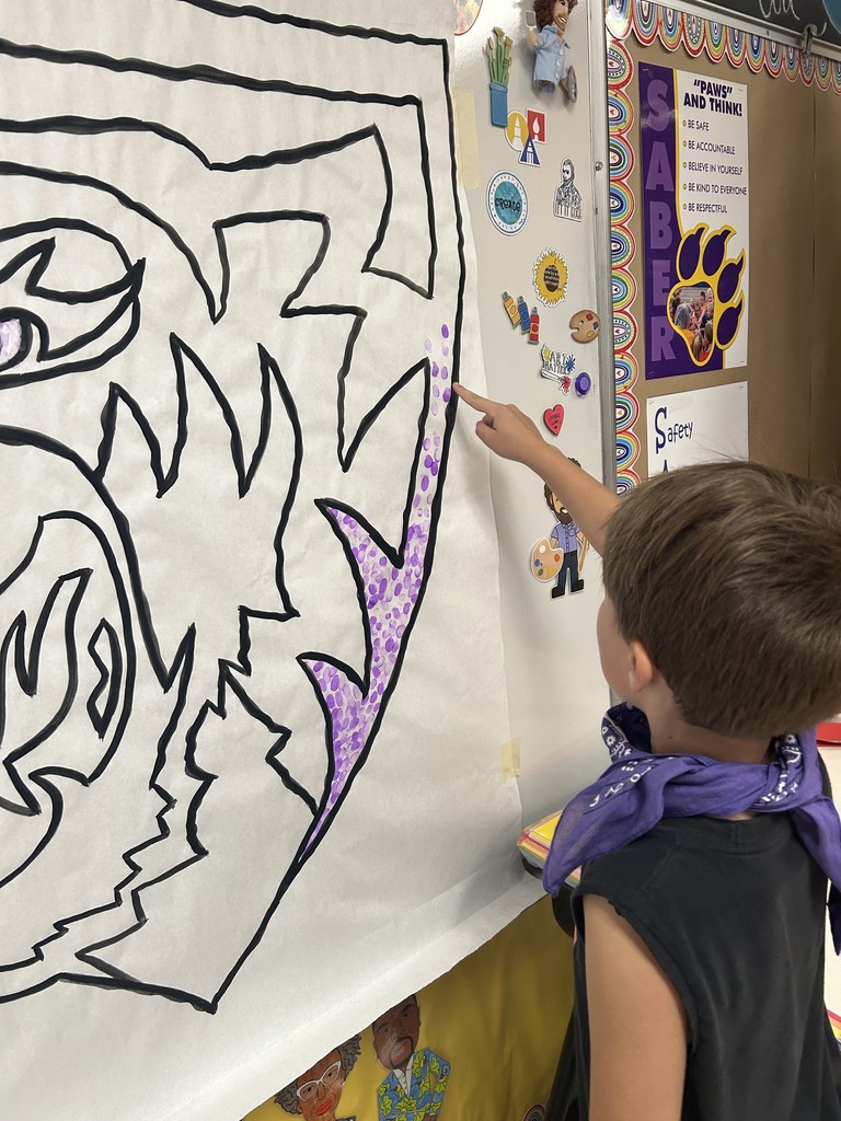 Students putting their fingerprint on Saber Spirit art project