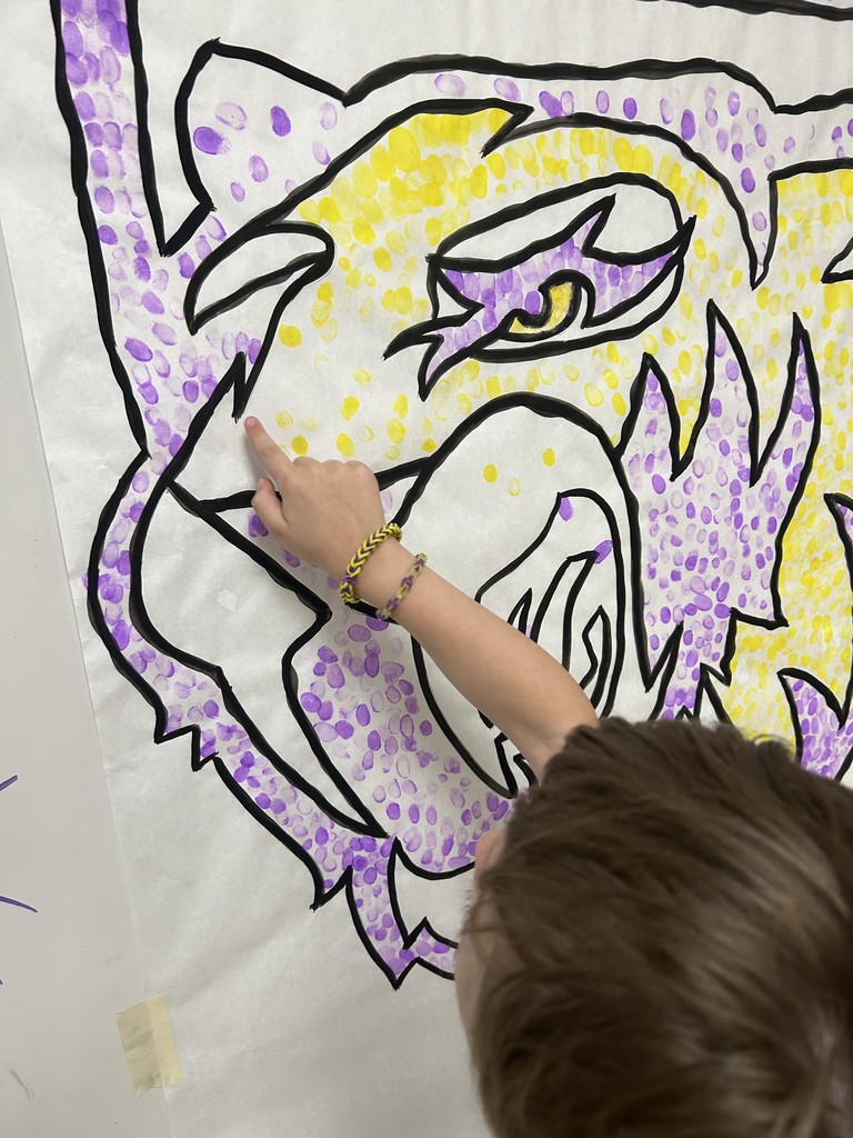 Students putting their fingerprint on Saber Spirit art project
