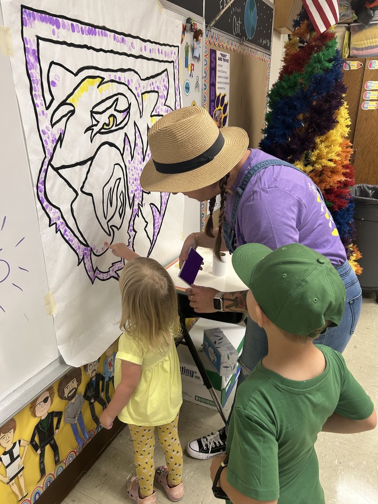 Students putting their fingerprint on Saber Spirit art project