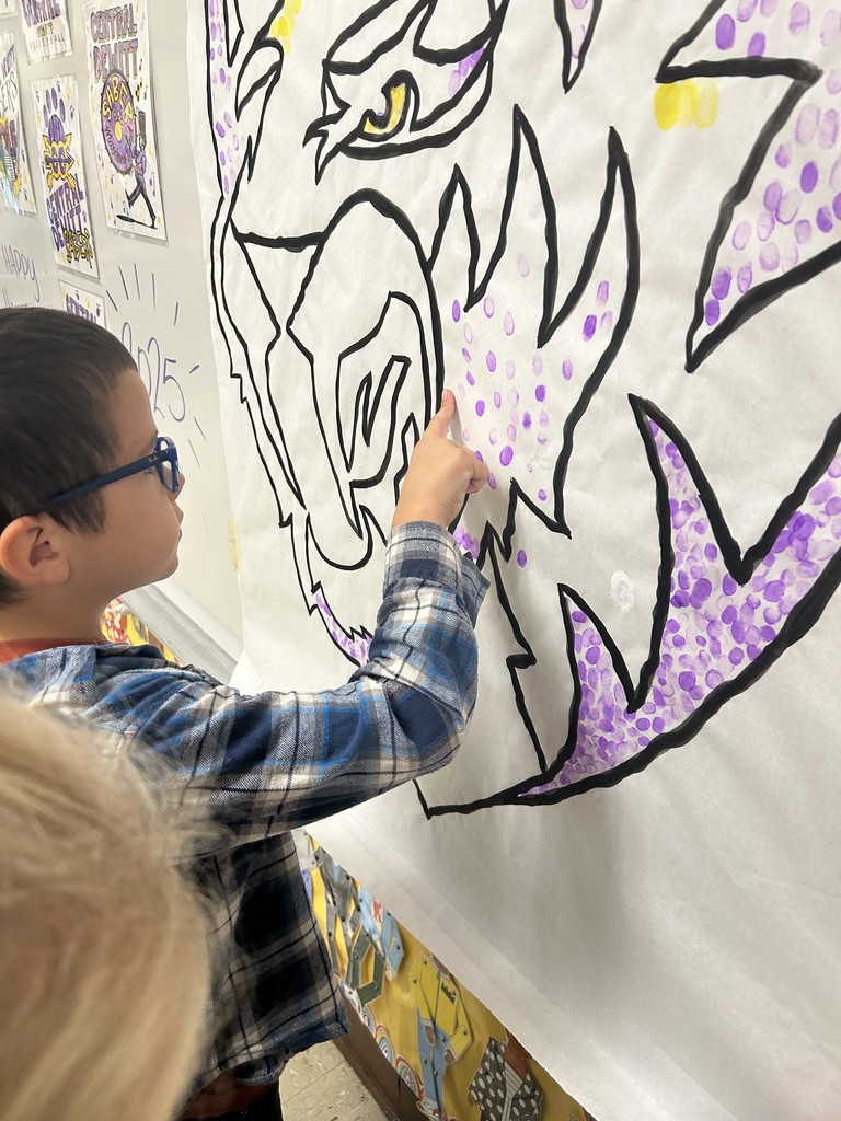 Students putting their fingerprint on Saber Spirit art project