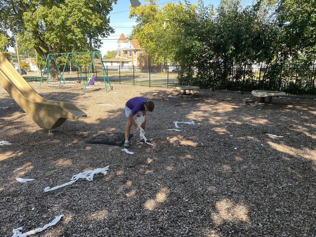 Saber football team cleaning up toilet paper in Lincoln Park