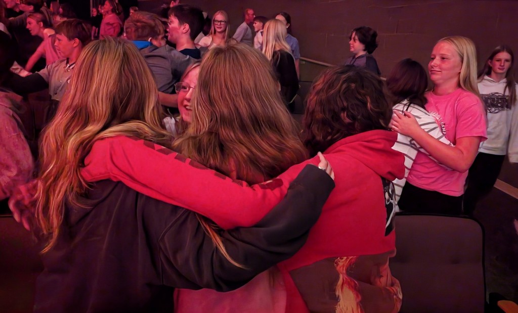 Students hugging during assembly