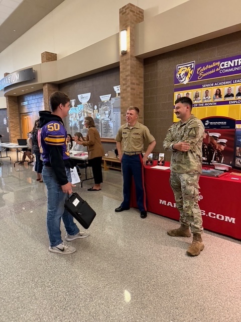 Student talking with military representatives