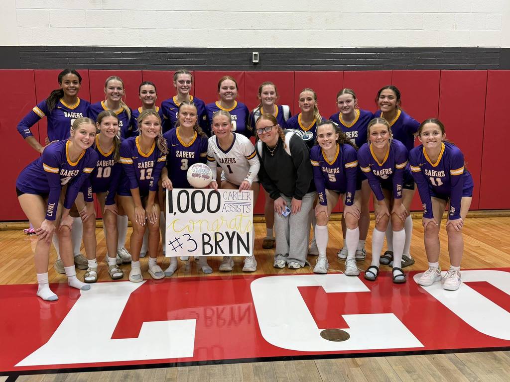 Saber Volleyball team celebrating Brynlee Shimp's 1,000 assists!