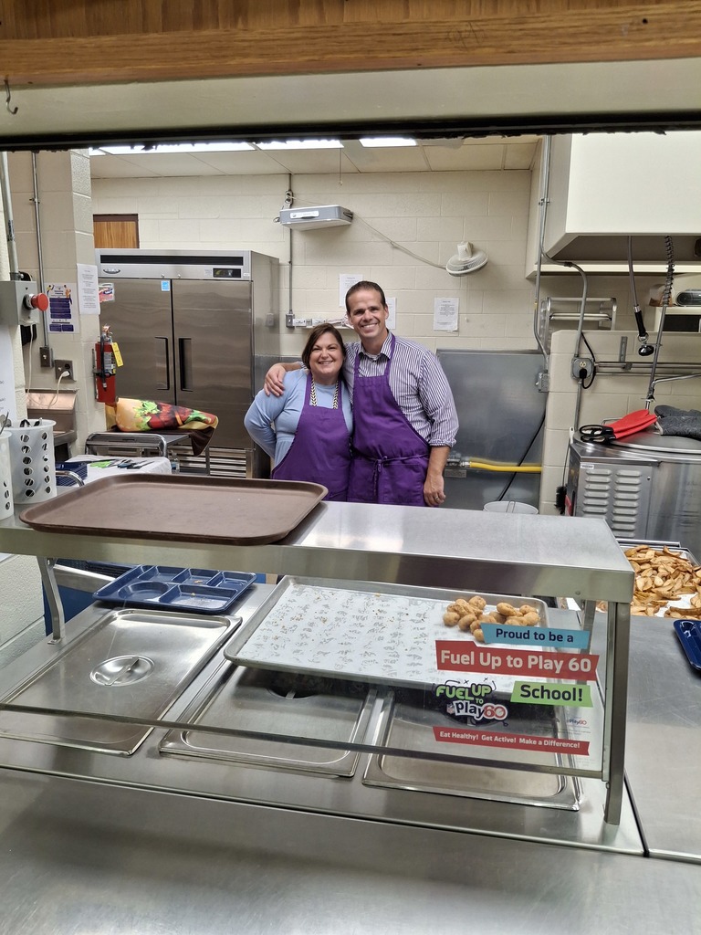 Mr. Miller and Mrs. Sikkema serving lunch at Ekstrand