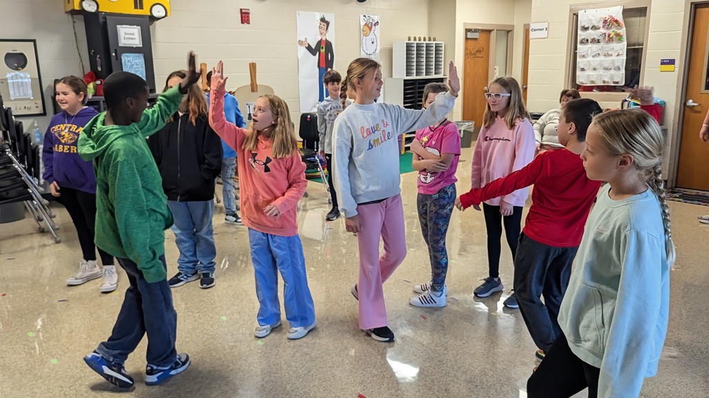 Students in Peer Stem class celebrating after successfully singing "Going on a Bear Hunt"