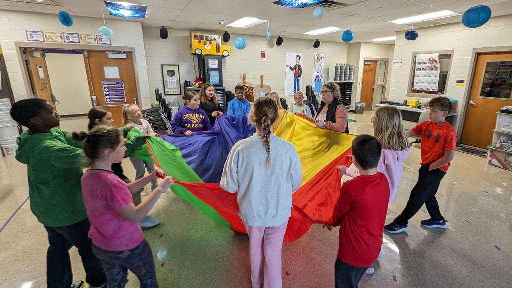 Students in Peer Stem class using a parachute while singing "Going on a Bear Hunt"