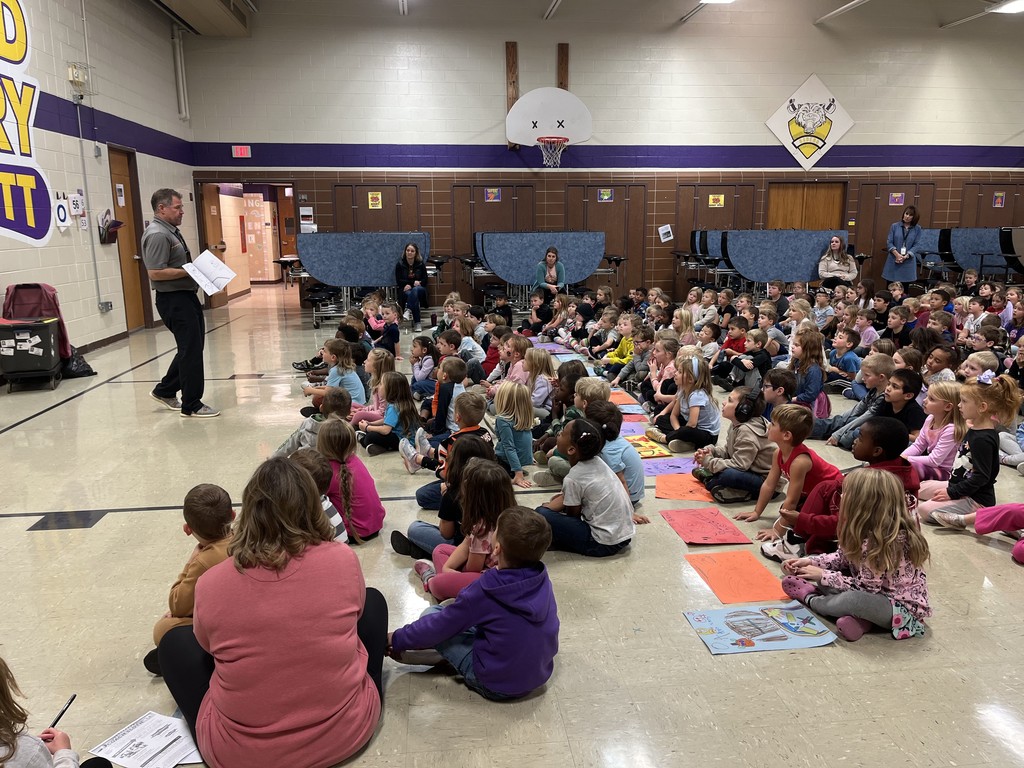 Coach Sloth wowing elementary students with his "Magic" coloring book