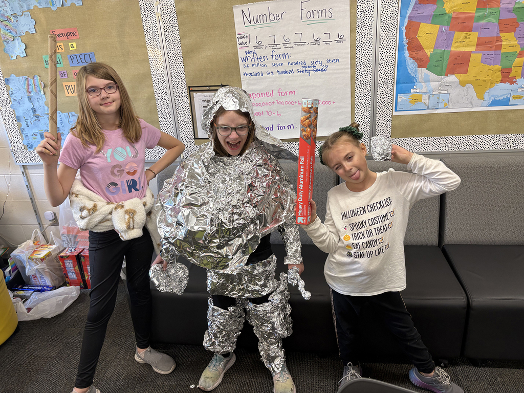 Fourth grade students creating a knight's  armor out of tin foil