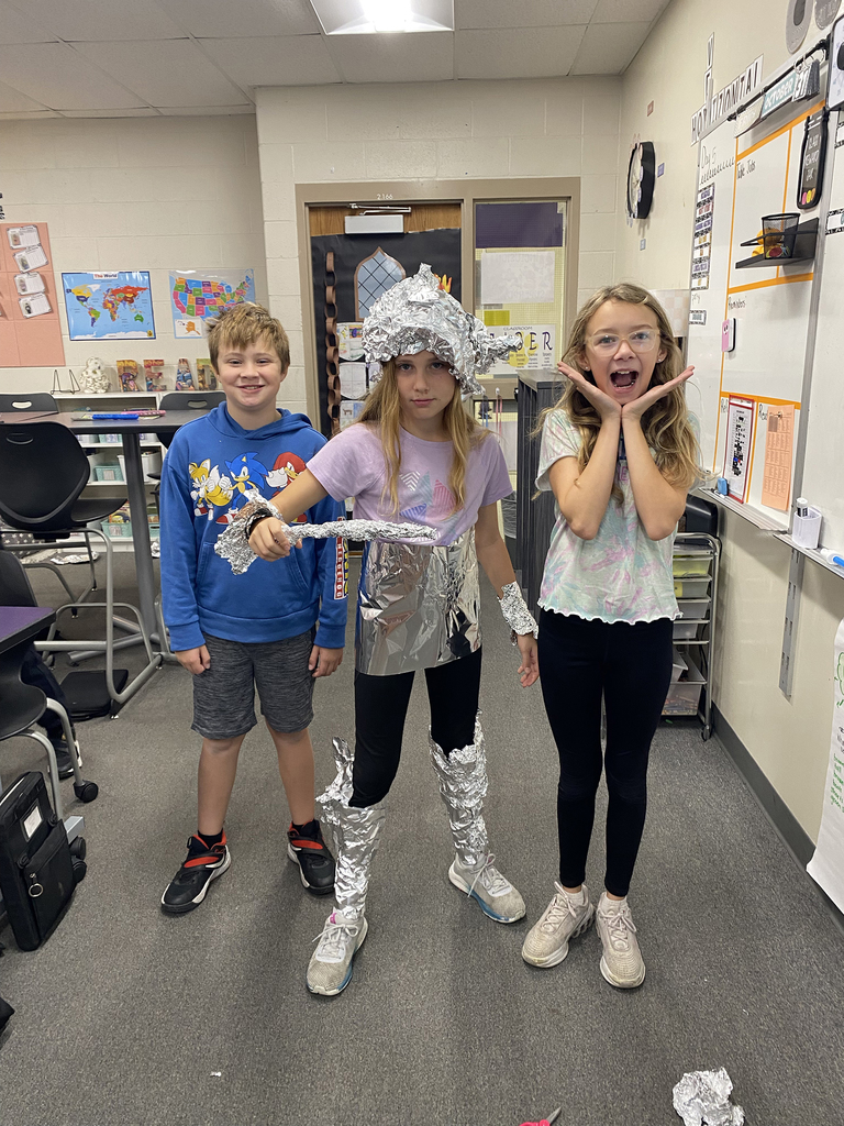 Fourth grade students creating a knight's  armor out of tin foil