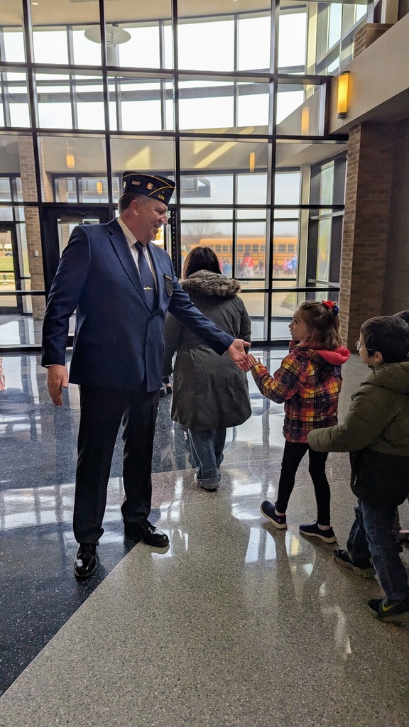 Student high-fiving a veteran