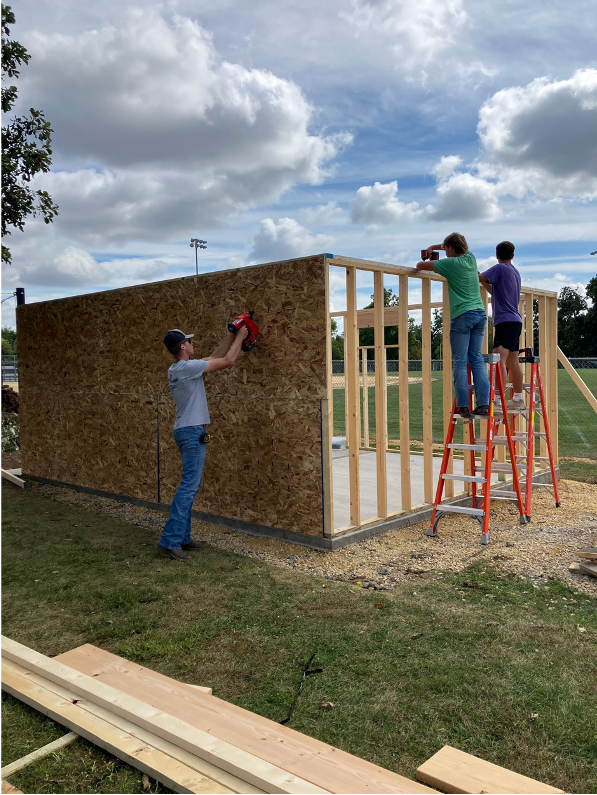 Students learning how to frame a shed