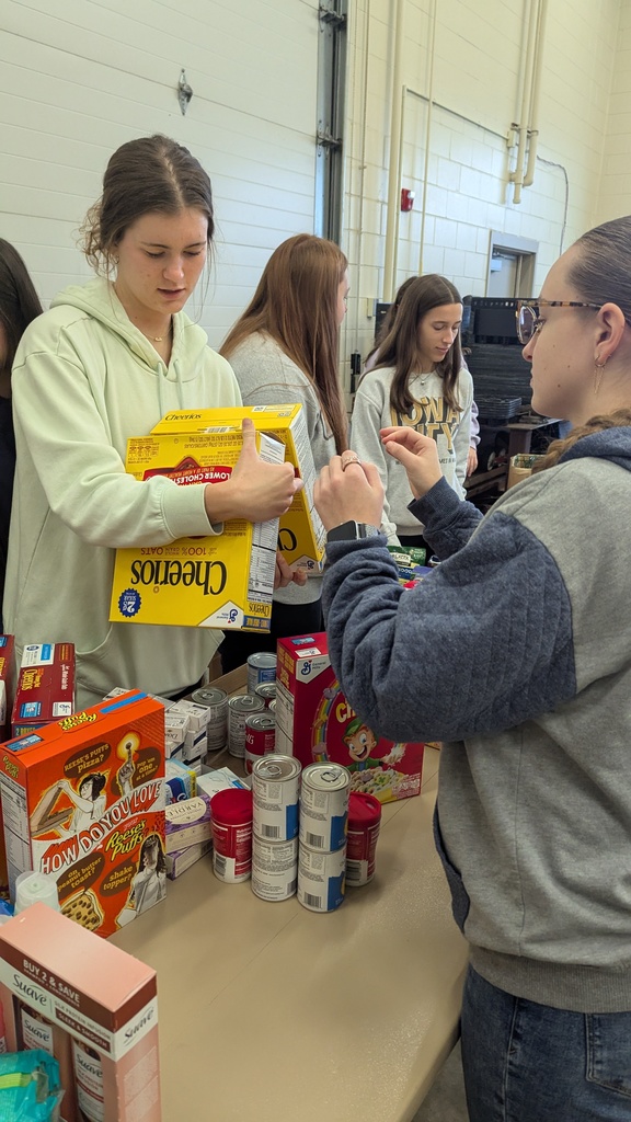 NHS students putting together Thanksgiving baskets for families in need