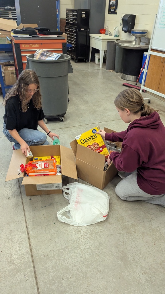 NHS students putting together Thanksgiving baskets for families in need