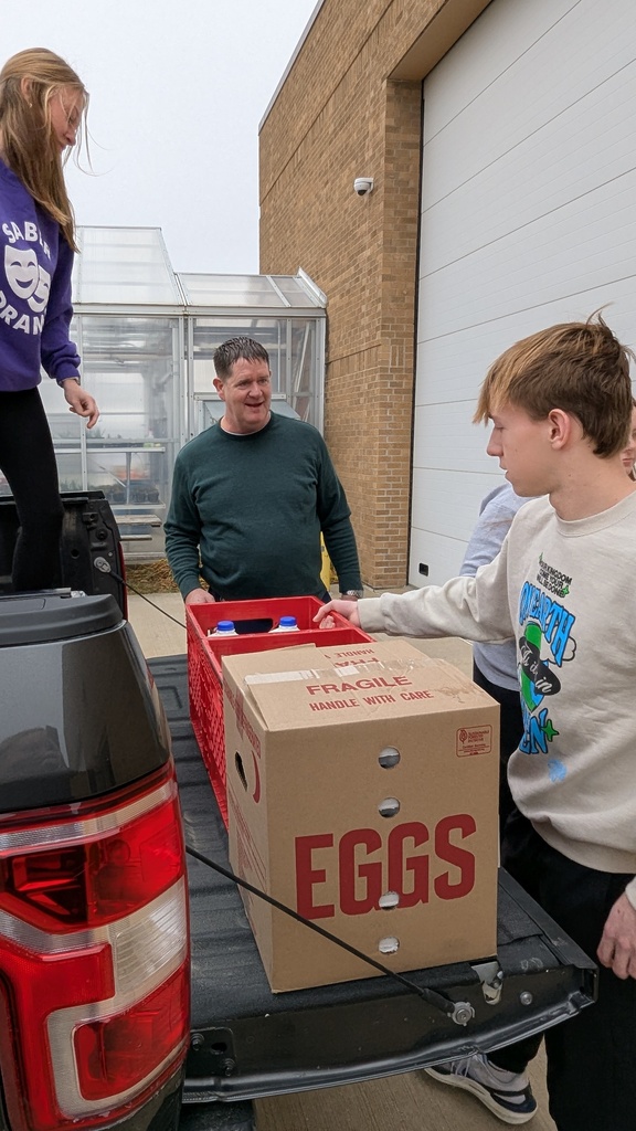 NHS students putting together Thanksgiving baskets for families in need